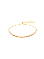 Gold beaded bracelet on a white background