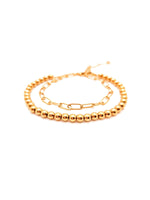 Gold beaded bracelet on a white background