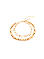 Two gold necklaces on a white background