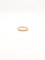 Gold ring with small diamonds on a white background