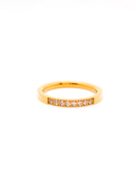 Gold ring with small diamonds on a white background
