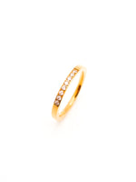 Gold ring with small diamonds on a white background