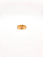 Gold ring with embedded stones on a white background