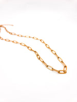 Gold chain necklace on a white background