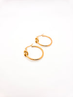 Gold hoop earrings on a white background