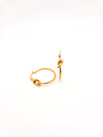 Gold hoop earrings on a white background