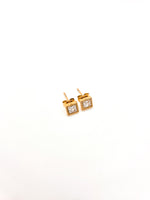Gold square earrings with clear gemstones on a white background