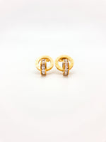 Gold earrings with embedded stones on a white background