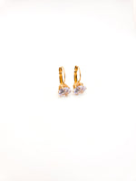Gold hoop earrings with clear gemstones on a white background