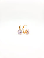 Gold hoop earrings with clear gemstones on a white background