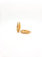 Gold hoop earrings on a white background