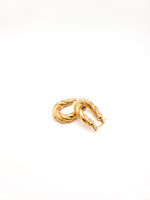 Gold hoop earrings on a white background