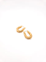 Gold hoop earrings on a white background
