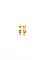 Gold hoop earrings on a white background