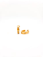 Gold hoop earrings with small stones on a white background