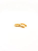 Gold ring with embedded stones on a white background