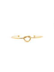 Gold bracelet with a knot design on a white background