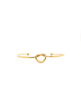Gold bracelet with a knot design on a white background