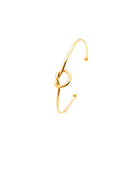 Gold knot bangle on a white background