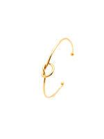 Gold bracelet with a knot design on a white background
