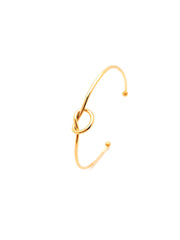 Gold bracelet with a knot design on a white background