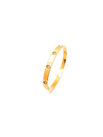 Gold bracelet with small stones on a white background