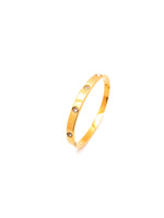 Gold bracelet with small stones on a white background