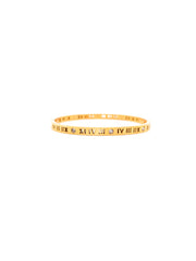 Gold bracelet with Roman numeral design on a white background