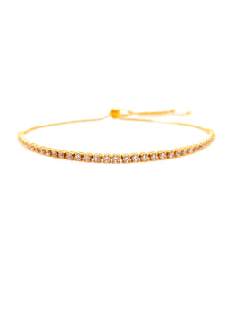 Gold bracelet with small stones on a white background