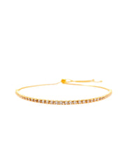 Gold bracelet with clear stones on a white background