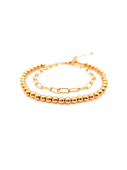 Gold beaded bracelet on a white background