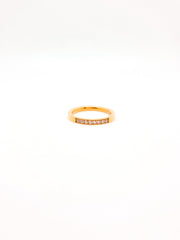 Gold ring with small diamonds on a white background