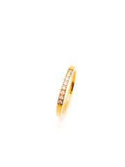 Gold ring with small diamonds on a white background