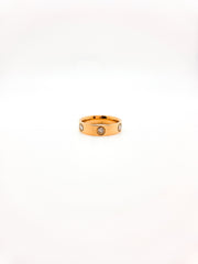 Gold ring with embedded stones on a white background