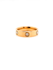 Gold ring with embedded diamonds on a white background