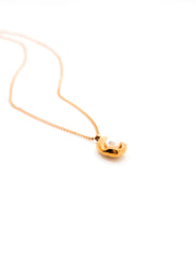 Gold necklace with a heart-shaped pendant on a white background