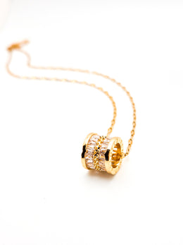 Gold necklace with a unique pendant on a white background