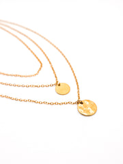 Gold necklaces with round pendants on a white background