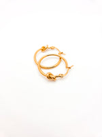 Gold hoop earrings on a white background