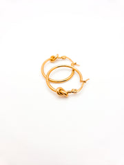 Gold hoop earrings on a white background
