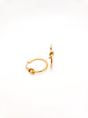 Gold hoop earrings on a white background
