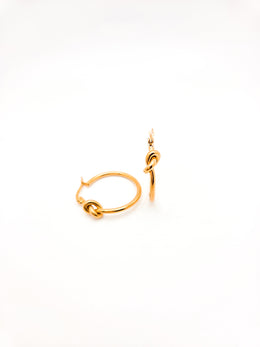Gold hoop earrings on a white background