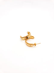 Gold hoop earring on a white background