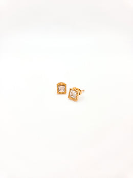 Gold square earrings with clear gemstones on a white background