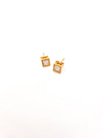 Gold square earrings with clear stones on a white background