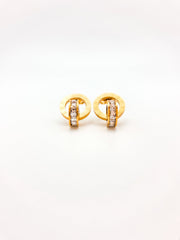 Gold earrings with embedded stones on a white background