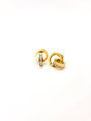 Pair of gold earrings with diamond accents on a white background
