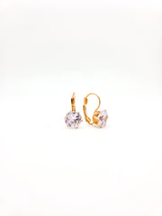 Gold hoop earrings with clear gemstones on a white background