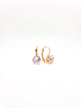 Gold hoop earrings with clear gemstones on a white background