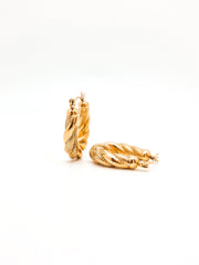 Pair of gold hoop earrings on a white background